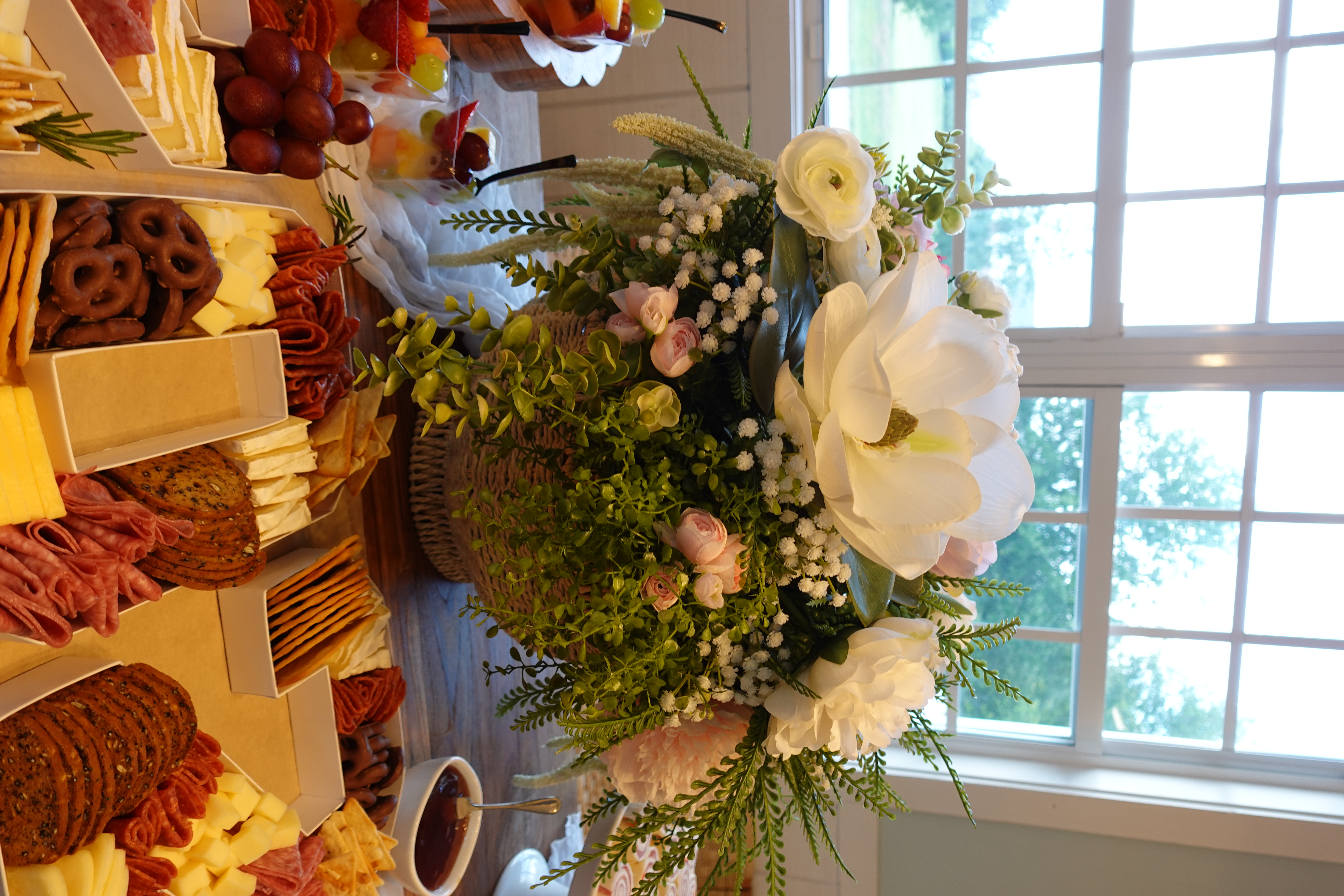 Elegant grazing table display with floral arrangement at a Palm Ave Catering event