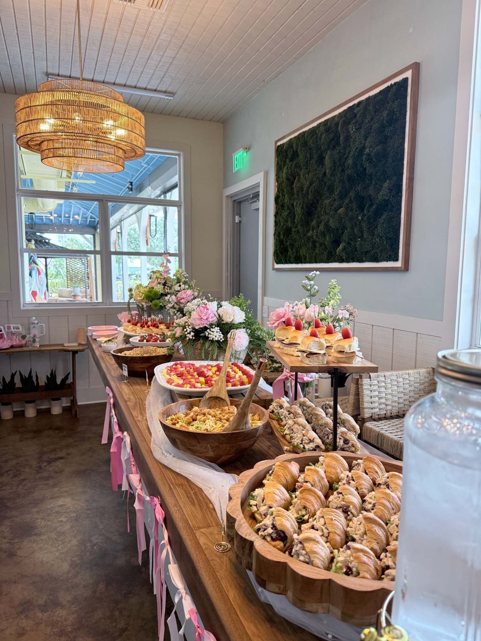 Full bridal shower buffet table with florals, sliders, croissants, and fresh fruit — Palm Ave Catering