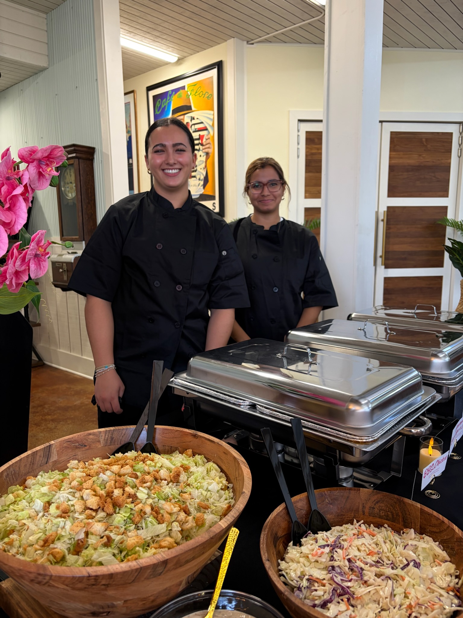 Palm Ave Catering team in black chef uniforms smiling at an event